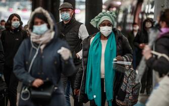 epa08414087 Commuters wearing face masks exit at the Saint Lazare rail station in Paris, France 11 May 2020. France begins a gradual easing of lockdow measures and restrictions although the coronavirus Covid-19 epidemic remains active. In Paris, workers need an attestation from their employer to justify using public transports.  EPA/CHRISTOPHE PETIT TESSON