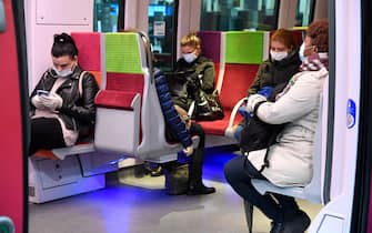 Passengers wearing protective facemasks sit within a train carriage as it prepares to depart from Saint-Lazare Railway Station in Paris on May 11, 2020, on the first day of France's easing of lockdown measures in place for 55 days to curb the spread of the COVID-19 pandemic, caused by the new coronavirus. (Photo by BERTRAND GUAY / AFP)