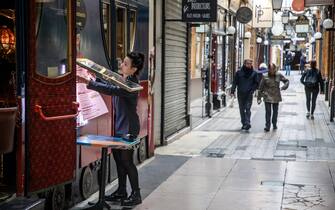 epa08414137 A merchant is preparing to reopen her shop in Paris, France 11 May 2020. France begins a gradual easing of lockdow measures and restrictions although the coronavirus Covid-19 epidemic remains active.  EPA/CHRISTOPHE PETIT TESSON