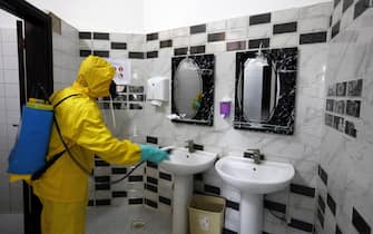 epa08319690 A Yemeni worker wearing a protective suit disinfects a bathroom of an office amid concerns over the spread of the coronavirus Covid-19, in Sanaa, Yemen, 24 March 2020. Yemen is taking increased precautionary measures to stem the widespread of the SARS-CoV-2 Coronavirus which causes the Covid-19 disease, calling on people to stay home and avoid large gatherings. Yemen has no confirmed cases of the coronavirus.  EPA/YAHYA ARHAB