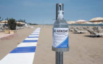 VENICE, ITALY - MAY 23: A bottle of sanitizing gel is set up as beaches reopen in Lido on May 23, 2020 in Venice, Italy. Restaurants, bars, cafes, hairdressers and other shops have reopened, subject to social distancing measures, after more than two months of a nationwide lockdown meant to curb the spread of COVID-19. (Photo by Simone Padovani/Awakening/Getty Images)