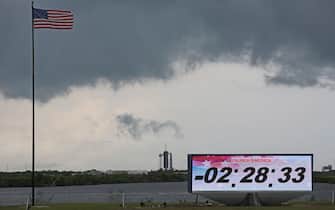 Ominous weather is seen above launch pad 39A at Cape Canaveral as the countdown clock continues  on launch day at the Kennedy Space Center in Florida on May 27, 2020. - SpaceX's historic first crewed launch was set to proceed as scheduled Wednesday, NASA announced at midday, but some uncertainty remained over weather conditions just over four hours before takeoff. "We are go for launch!" tweeted NASA chief Jim Bridenstine. "@SpaceX and @NASA will continue monitoring liftoff and downrange weather as we step into the countdown. We are proceeding toward a 4:33 launch." (Photo by Gregg Newton / Gregg Newton / AFP) (Photo by GREGG NEWTON/Gregg Newton/AFP via Getty Images)