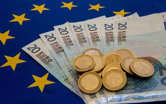 478960586 A picture taken on June 29, 2015 in Lille shows Drachma bills, Greece's former currency, next to euro bills and coins. The European single currency briefly dropped below $1.1 today as investors grow concerned Greece is headed for a debt default and a possible eurozone exit. AFP PHOTO / DENIS CHARLET (Photo credit should read DENIS CHARLET/AFP via Getty Images)