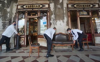 Three waiters work outside the historic  Caffè Florian in San Marco square in Venice, Italy, 12 June 2020. ANSA / ANDREA MEROLA