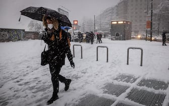 A man walks at Corso Lodi during snowfall in Milan, Italy, 28 December 2020. Ansa/Matteo Corner