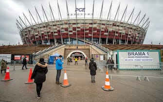 Visitors at an entrance to a Covid-19 vaccination center in Poland's National Stadium in Warszawa, Poland, on Friday, March 12, 2021. Eastern Europe is struggling to contain a growing wave of coronavirus infections, even as an accelerating global vaccine rollout is raising optimism about the end of the pandemic. Photographer: Lukasz Sokol/Bloomberg via Getty Images