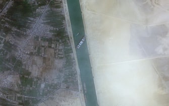 epa09096521 A handout satellite image made available by European Space Agency Copernicus Sentinel-2 Satellite Image via Maxar Technologies shows the container ship 'Ever Given' run aground in the Suez Canal, Egypt, 24 March 2021 (issued 25 March 2021). The large container ship Ever Given ran aground in the Suez Canal on 23 March, blocking passage of other ships and causing a traffic jam for cargo vessels. The head of the Suez Canal Authority announced on 25 March that 'the navigation through the Suez Canal is temporarily suspended' until the floatation of the Ever Given is completed. Its floatation is being carried out by eight large tugboats that are towing and pushing the grounding vessel.  EPA/European Space Agency Copernicus Sentinel-2 Satellite Image /via -- MANDATORY CREDIT: SATELLITE IMAGE 2020 MAXAR TECHNOLOGIES -- the watermark may not be removed/cropped -- HANDOUT EDITORIAL USE ONLY/NO SALES