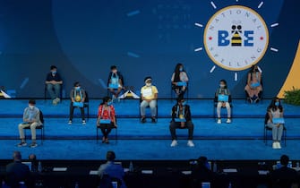 The 11 finalists of the Scripps National Spelling Bee sit on stage as the Finals begins, during a visit by US First Lady Jill Biden, in Orlando, Florida on July 8, 2021. (Photo by JIM WATSON / POOL / AFP) (Photo by JIM WATSON/POOL/AFP via Getty Images)