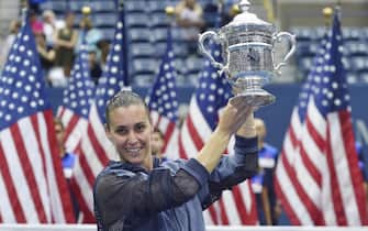 Flavia Pennetta of Italy celebrates with the championship trophy after defeating Roberta Vinci of Italy in the women's final on the thirteenth day of the 2015 US Open Tennis Championship at the USTA National Tennis Center in Flushing Meadows, New York, USA, 12 September 2015. ANSA/JUSTIN LANE