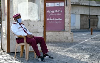 epa08317554 A security guard wearing a protective mask keeps watch at the entrance of the historic part of Jeddah, Saudi Arabia, 24 March 2020. According to local media reports Saudi Arabia has registered 51 new cases on 23 March bringing the total to 562 cases, 19 of them have recovered. Saudi Arabia's King Salman bin Abdulaziz Al Saud has announced a nation-wide curfew from dawn to dusk starting from 24 March for the duration of 21 days.  EPA/ALI AHMAD