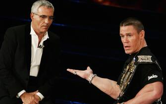 San Remo, ITALY:  Italian presenter Giorgio Panariello (L) and US wrestling champion John Cena appear together on the stage of the Ariston Theatre in San Remo during the 56th Italian music festival , 02 March 2006. AFP PHOTO/Tiziana Fabi  (Photo credit should read TIZIANA FABI/AFP via Getty Images)