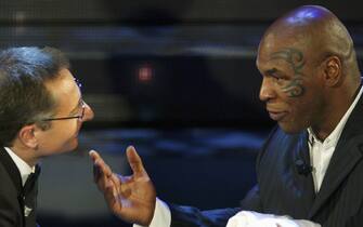 SAN REMO, ITALY - MARCH 2:  Mike Tyson (R) and Paolo Bonolis attend the second day of the San Remo Festival at the Ariston Theatre on March 2, 2005 in San Remo, Italy. The five-day singing competition, organised by Rai Television, has welcomed such stars as Tina Turner, Peter Gabriel, and Andrea Boccelli in the past. Last year's festival was shrouded in controversy because Tony Renis, recently appointed artistic director of the festival, allegedly has close links with the Mafia. An alternative festival, the Mantova Musica Festival, was organised in protest at his appointment. (Photo by Giuseppe Cacace/Getty Images)