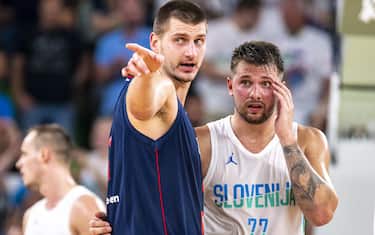 LJUBLJANA, SLOVENIA - AUGUST 17: Luka Doncic of Slovenia and Nikola Jokic of Serbia react during the basketball friendly match between Slovenia and Serbia in Arena Stozice, on August 17, 2022 in Ljubljana, Slovenia. (Photo by Jurij Kodrun/Getty Images)