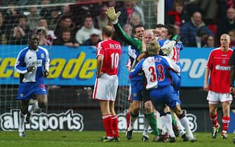 LONDON - FEBRUARY 21:  Brad Friedel of Blackburn Rovers is mobbed by his team mates after he scores their second goal during the FA Barclaycard Premiership match between Charlton Athletic and Blackburn Rovers at The Valley on February 21, 2004 in London.  (Photo by Phil Cole/Getty Images)