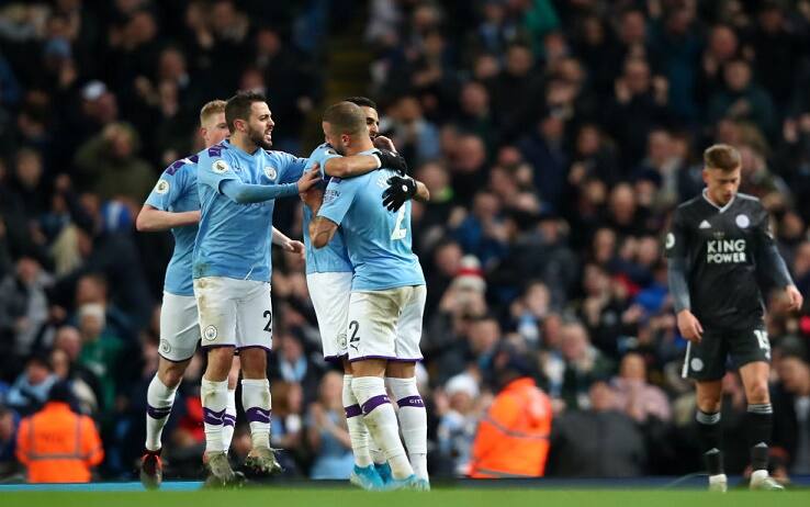 MANCHESTER, ENGLAND - DECEMBER 21: Riyad Mahrez of Manchester City celebrates with teammates after scoring his team's first goal during the Premier League match between Manchester City and Leicester City at Etihad Stadium on December 21, 2019 in Manchester, United Kingdom. (Photo by Clive Brunskill/Getty Images)