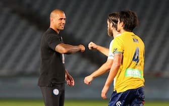 GOSFORD, AUSTRALIA - MARCH 20: Patrick Kisnorbo interim Coach for Melbourne City fist bumps Josh Brillante of Melbourne City during the round 24 A-League match between the Central Coast Mariners and Melbourne City at Central Coast Stadium on March 20, 2020 in Gosford, Australia. (Photo by Ashley Feder/Getty Images)