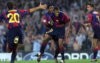 BARCELONA, SPAIN:  Barca's Brazilian Rivaldo (C) is congratulated by team-mates Kluivert (back) and Overmars (R) after he scored the first goal during their first round, first leg match Barcelona vs Leeds at Nou Camp stadium 13 September 2000 in Barcelona. AFP PHOTO CHRISTOPHE SIMON (Photo credit should read CHRISTOPHE SIMON/AFP via Getty Images)