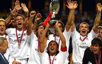 Paolo Maldini of AC Milan holds up the cup celebrating together with his team-mates just after their victory in the UEFA Super Cup match against FC Porto, in Monte Carlo, Monaco, on Friday 29 August 2003. AC Milan won the game 1:0. EPA PHOTO/EPA/SRDJAN SUKI//