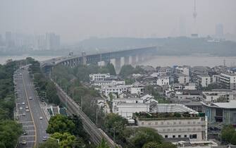 View of the Wuhan Bridge (C) and Tortoise Mountain TV Tower (R) scene from Yellow Crane Tower in Wuhan, in China's central Hubei province on April 10, 2020. (Photo by Hector RETAMAL / AFP) (Photo by HECTOR RETAMAL/AFP via Getty Images)