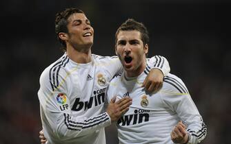 Real Madrid's Argentinian forward Gonzalo Higuain (R) celebrates with Portuguese forward Cristiano Ronaldo after scoring against Sporting Gijon during their Spanish League football match at Santiago Bernabeu stadium in Madrid on March 20, 2010.    AFP PHOTO/ PIERRE-PHILIPPE MARCOU (Photo credit should read PIERRE-PHILIPPE MARCOU/AFP via Getty Images)