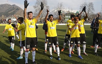 In this photo taken on January 28, 2019, Real Kashmir's players wave to fans after winning their I-League club football match against Chennai City FC at the Tourist Reception Centre football ground in Srinagar. - Real Kashmir is the first club from the war-torn Himalayan region to make it into India's top football league. With the help of Scottish coach David Robertson, the Snow Leopards have emerged as serious title contenders in their debut I-League season and on February 6 beat Gokulam Kerala 1-0 to go top of the table. (Photo by Tauseef MUSTAFA / AFP) / TO GO WITH Fbl-IND-unrest-KAshmir, FOCUS by Abhaya SRIVASTAVA        (Photo credit should read TAUSEEF MUSTAFA/AFP via Getty Images)