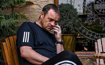 In this photo taken on April 11, 2020, Real Kashmir Football Club (RKFC) coach David Robertson of Scotland uses his mobile phone at a restaurant hotel during a government-imposed nationwide lockdown as a preventive measure against the COVID-19 coronavirus, in Srinagar. - Stranded by the coronavirus lockdown in one of the world's most militarised regions, Zambia's Aaron Katebe is one of 10 foreign footballers reduced to playing video games or training in a hotel gym in Indian-administered Kashmir. (Photo by Tauseef MUSTAFA / AFP) (Photo by TAUSEEF MUSTAFA/AFP via Getty Images)