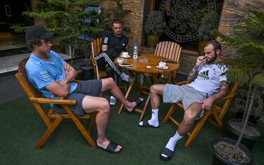 In this photo taken on April 11, 2020, Real Kashmir Football Club (RKFC) players Kallum Higginbotham (R) of England, Mason Robertson of Scotland and coach David Robertson (C) sit at a restaurant hotel during a government-imposed nationwide lockdown as a preventive measure against the COVID-19 coronavirus, in Srinagar. - Stranded by the coronavirus lockdown in one of the world's most militarised regions, Zambia's Aaron Katebe is one of 10 foreign footballers reduced to playing video games or training in a hotel gym in Indian-administered Kashmir. (Photo by Tauseef MUSTAFA / AFP) (Photo by TAUSEEF MUSTAFA/AFP via Getty Images)