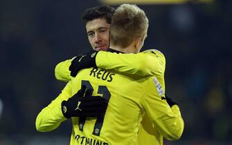 epa03555588 Robert Lewandowski (L) of Borussia Dortmund celebrates a score with teammate Marco Reus during German Bundesliga match in Dortmund, Germany, 25 January 2013. 
(ATTENTION: EMBARGO CONDITIONS! The DFL permits the further utilisation of up to 15 pictures only (no sequntial pictures or video-similar series of pictures allowed) via the internet and online media during the match (including halftime), taken from inside the stadium and/or prior to the start of the match. The DFL permits the unrestricted transmission of digitised recordings during the match exclusively for internal editorial processing only (e.g. via picture databases)  EPA/KEVIN KUREK