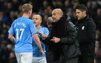 Manchester City's Spanish manager Pep Guardiola (R) talks with Manchester City's Belgian midfielder Kevin De Bruyne (L) after their first goal in the second half during the English Premier League football match between Manchester City and Manchester United at the Etihad Stadium in Manchester, north west England, on December 7, 2019. (Photo by Lindsey Parnaby / AFP) / RESTRICTED TO EDITORIAL USE. No use with unauthorized audio, video, data, fixture lists, club/league logos or 'live' services. Online in-match use limited to 120 images. An additional 40 images may be used in extra time. No video emulation. Social media in-match use limited to 120 images. An additional 40 images may be used in extra time. No use in betting publications, games or single club/league/player publications. /  (Photo by LINDSEY PARNABY/AFP via Getty Images)