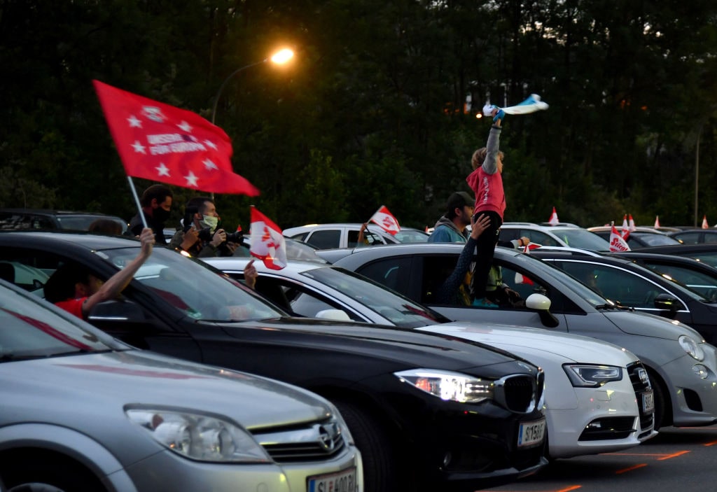 1216202805 Football fans follow the Austrian Cup final between FC Red Bull Salzburg and SC Austria Lustenau on a giant screen from their cars at a drive-in in Salzburg on May 29, 2020. (Photo by BARBARA GINDL / APA / AFP) / Austria OUT (Photo by BARBARA GINDL/APA/AFP via Getty Images)