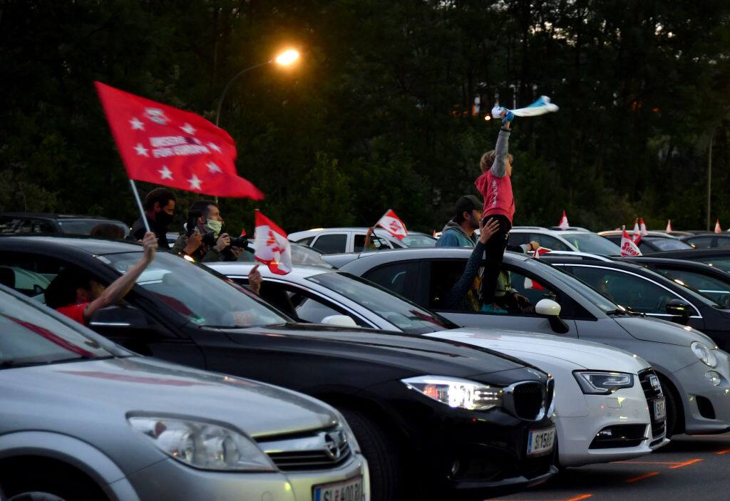 Football fans follow the Austrian Cup final between FC Red Bull Salzburg and SC Austria Lustenau on a giant screen from their cars at a drive-in in Salzburg on May 29, 2020. (Photo by BARBARA GINDL / APA / AFP) / Austria OUT (Photo by BARBARA GINDL/APA/AFP via Getty Images)