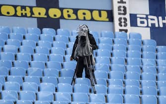 epa08453146 A TV camera in the empty stands during the Serbian SuperLiga soccer match between Rad and Red Star in Belgrade, Serbia, 29 May 2020. The Serbian SuperLiga resumes without spectators after a suspension because of the coronavirus pandemic.  EPA/ANDREJ CUKIC