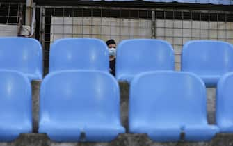 epa08453099 A police officers wearing protective face mask stands guard before the Serbian SuperLiga soccer match between Rad and Red Star in Belgrade, Serbia, 29 May 2020. The Serbian SuperLiga resumes without spectators after a suspension because of the coronavirus pandemic.  EPA/ANDREJ CUKIC