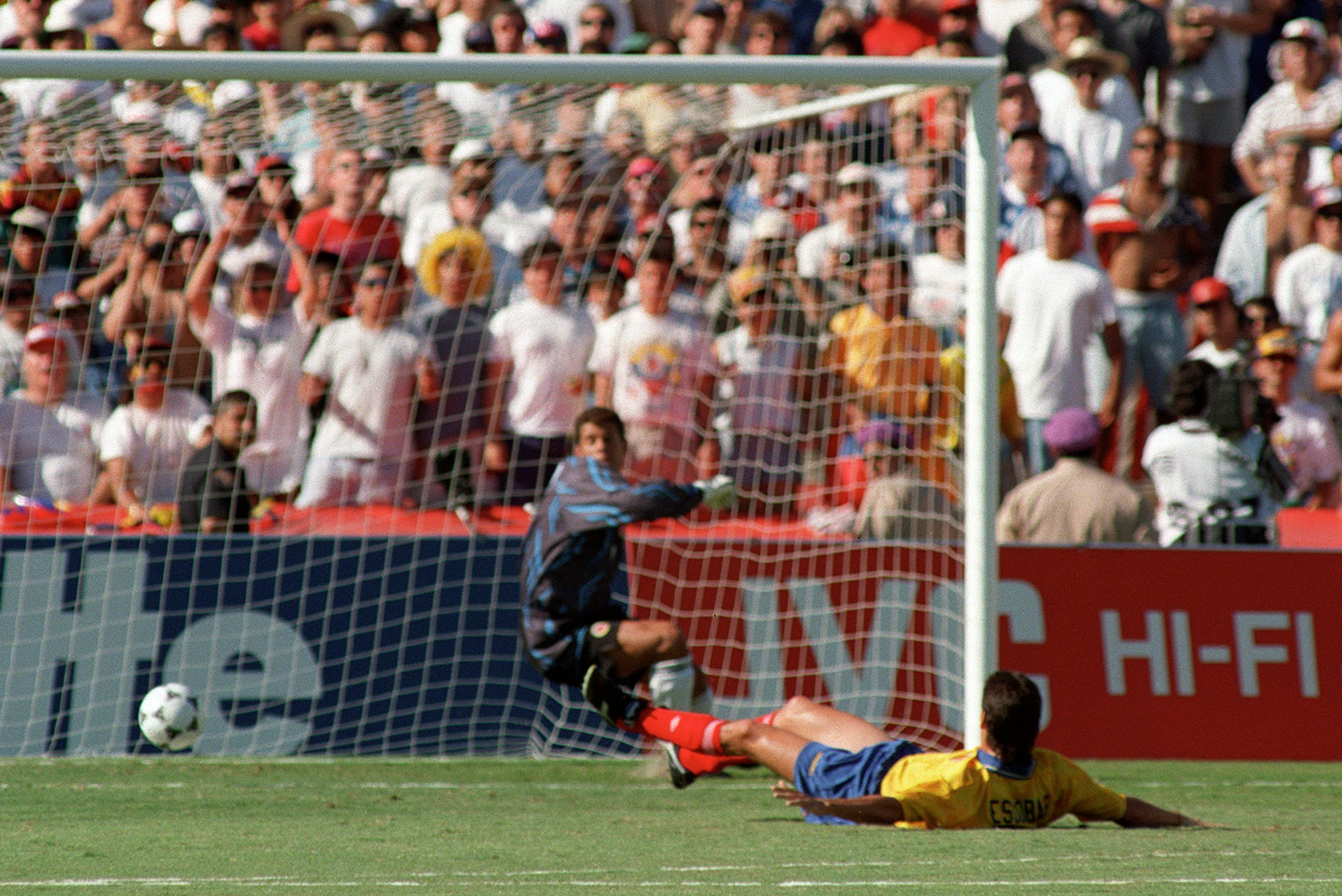 Colombian defender Andres Escobar lies on the ground after scoring an own goal past goalkeeper Oscar Cordoba while trying to stop a shot from US forward John Harkes during the World Cup first round soccer match between the United States and Colombia 22 June 1994 in Los Angeles. The United States beat Colombia 2-1. AFP PHOTO/ROMEO GACAD (Photo by Romeo GACAD / AFP) (Photo by ROMEO GACAD/AFP via Getty Images)