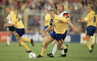SOLNA, SWEDEN - JUNE 21:  Tomas Brolin of Sweden takes the ball past Andreas Brehme of Germany during the UEFA European Championships 1992 Semi-Final between Sweden and Germany held at the Rasunda Stadium on June 21, 1992 in Solna, Sweden. (Photo by Simon Bruty/Allsport/Getty Images)