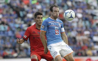 Cruz Azul's Gerardo Torrado (R) in action against Morelia's Hibert Ruiz (L) during their Apertura tournament's match at Azul Stadium in Mexico City, Mexico, 25 July 2015. Morelia won 0-3. EFE/Alex Cruz