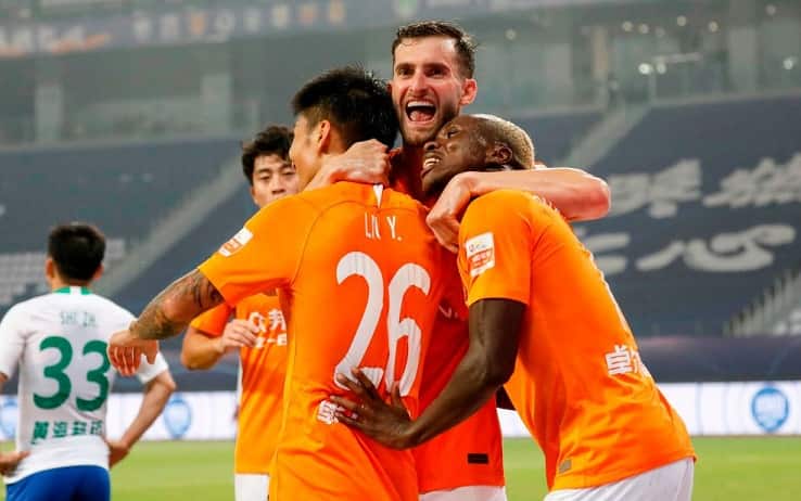 Players of Wuhan Zall celebrate after scored during their Chinese Super League (CSL) football match with Qingdao Huanghai in Suzhou in China's eastern Jiangsu province on July 25, 2020. - Wuhan Zall players were given a guard of honour and medical staff from the city were applauded as Chinese football made an emotional return on July 25 following a long delay because of coronavirus. (Photo by STR / AFP) / China OUT (Photo by STR/AFP via Getty Images)