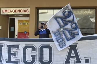 A supporter of Argentine former football star and coach of Gimnasia y Esgrima La Plata Diego Maradona, remains outside the Ipensa clinic where Maradona has been admitted, in La Plata, Buenos Aires province, on November 3, 2020. - Argentine football great Diego Maradona was admitted to hospital Monday for medical checks, his personal doctor announced. (Photo by JUAN MABROMATA / AFP) (Photo by JUAN MABROMATA/AFP via Getty Images)