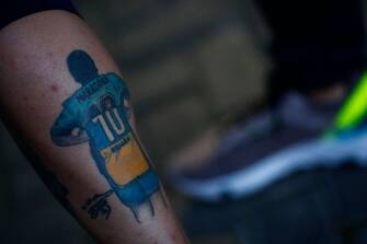OLIVOS, ARGENTINA - NOVEMBER 03: A fan of Diego Maradona shows a tattoo on November 03, 2020 in Olivos, Argentina. Personal doctor of Maradona, Leopoldo Luque, confirmed the former footballer will under a surgery to treat a clot in his brain. Maradona, who turned 60 on Friday 30, had spent the night of Monday hospitalized after being admitted with symptoms of depression. (Photo by Marcos Brindicci/Getty Images)