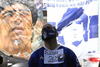 A supporter of Argentine former football star and coach of Gimnasia y Esgrima La Plata stays outside the Ipensa clinic where Maradona has been admitted, in La Plata, Buenos Aires province, on November 3, 2020. - Argentine football great Diego Maradona was admitted to hospital Monday for medical checks, his personal doctor announced. (Photo by JUAN MABROMATA / AFP) (Photo by JUAN MABROMATA/AFP via Getty Images)