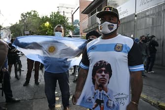 TOPSHOT - Supporters of Argentine former football star and coach of Gimnasia y Esgrima La Plata Diego Maradona gather outside the hospital where he will undergo brain surgery for a blood clot, in Olivos, Buenos Aires province, on November 3, 2020. (Photo by JUAN MABROMATA / AFP) (Photo by JUAN MABROMATA/AFP via Getty Images)