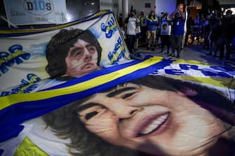 Supporters of Argentine former football star and coach of Gimnasia y Esgrima La Plata Diego Maradona gather outside the hospital where he undergoes a brain surgery for a blood clot, in Olivos, Buenos Aires province, on November 3, 2020. (Photo by JUAN MABROMATA / AFP) (Photo by JUAN MABROMATA/AFP via Getty Images)