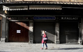 FLORENCE, ITALY - NOVEMBER 26: A jewellers on the old bridge, closed due to the red zone restrictions and awaiting government support, displays a sign on it's door reading" We Exist" on November 26, 2020 in Florence, Italy. While the whole country is in lockdown of varying degrees between regions, the contagions appear to be dropping. (Photo by Paolo Lo Debole/Getty Images)