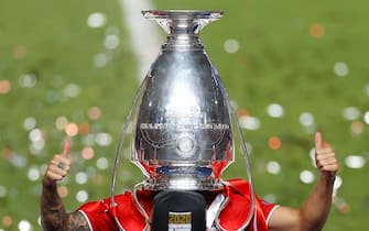 TOPSHOT - Bayern Munich's French defender Lucas Hernandez poses with the trophy upside down on his head after Bayern won the UEFA Champions League final football match between Paris Saint-Germain and Bayern Munich at the Luz stadium in Lisbon on August 23, 2020. (Photo by MATTHEW CHILDS / POOL / AFP) (Photo by MATTHEW CHILDS/POOL/AFP via Getty Images)