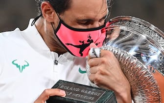 TOPSHOT - Spain's Rafael Nadal kisses the Mousquetaires Cup (The Musketeers) as he celebrates during the podium ceremony after winning the men's singles final tennis match against Serbia's Novak Djokovic at the Philippe Chatrier court, on Day 15 of The Roland Garros 2020 French Open tennis tournament in Paris on October 11, 2020. (Photo by Anne-Christine POUJOULAT / AFP) (Photo by ANNE-CHRISTINE POUJOULAT/AFP via Getty Images)