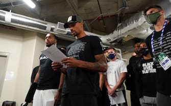 ORLANDO, FL - AUGUST 26: George Hill of the Milwaukee Bucks reads a statement to the media on August 26, 2020 at AdventHealth Arena at ESPN Wide World of Sports Complex in Orlando, Florida. NOTE TO USER: User expressly acknowledges and agrees that, by downloading and/or using this photograph, user is consenting to the terms and conditions of the Getty Images License Agreement.  Mandatory Copyright Notice: Copyright 2020 NBAE (Photo by Jesse D. Garrabrant/NBAE via Getty Images)