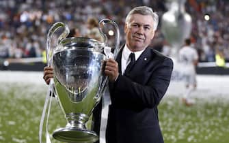 Real Madrid's Italian head coach Carlo Ancelotti holds the winner trophy during an event to celebrate their win in the UEFA Champions League held at Santiago Bernabeu stadium in Madrid, Spain on 25 May 2014. 
ANSA/Javier Lizon