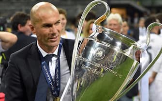 Real Madrid's coach Zinedine Zidane celebrates with the trophy at the end of the UEFA Champions League Final soccer match Real Madrid vs Atletico Madrid at the Giuseppe Meazza stadium in Milan, Italy, 28 May 2016. 
ANSA/DANIEL DAL ZENNARO