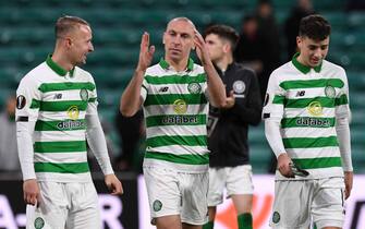 Celtic's Scottish midfielder Scott Brown (C), Celtic's Scottish forward Leigh Griffiths (L) and Celtic's Scottish midfielder Michael Johnston (R) celebrate on the pitch after the UEFA Europa League group E football match between Celtic and Rennes at Celtic Park stadium in Glasgow, Scotland on November 28, 2019. - Celtic won the game 3-1. (Photo by ANDY BUCHANAN / AFP) (Photo by ANDY BUCHANAN/AFP via Getty Images)