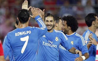 GRANADA, SPAIN - AUGUST 26:  Cristiano Ronaldo (L) and Karim Benzema (C) of Real Madrid celebrates after scoring during the match at Estadio Nuevo Los Carmenes on August 26, 2013 in Granada, Spain.  (Photo by Helios de la Rubia/Real Madrid via Getty Images)